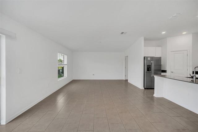 unfurnished living room featuring sink