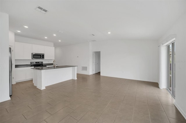 kitchen with appliances with stainless steel finishes, sink, a center island with sink, and white cabinets