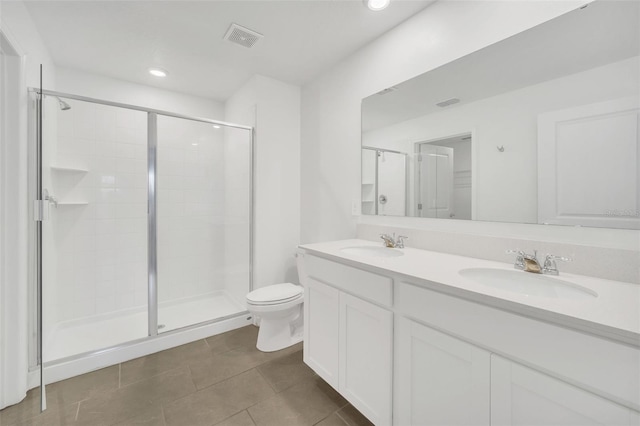 bathroom with walk in shower, vanity, toilet, and tile patterned flooring