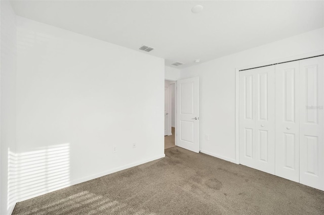 unfurnished bedroom with carpet and a closet