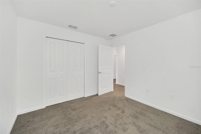 unfurnished bedroom featuring carpet flooring and a closet