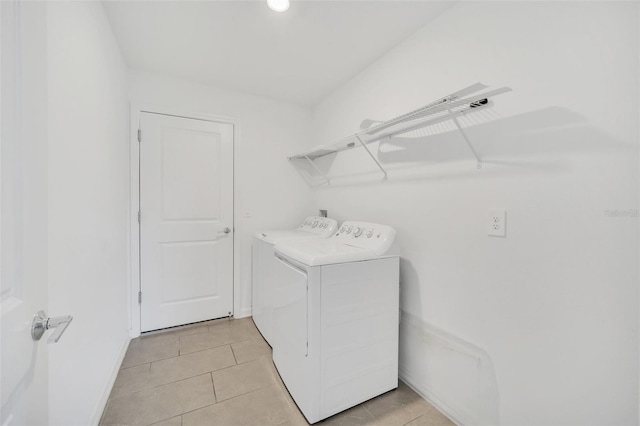 laundry room featuring light tile patterned floors and washer and clothes dryer