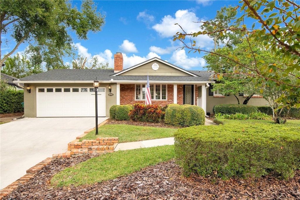 view of front of property with a garage and a front lawn