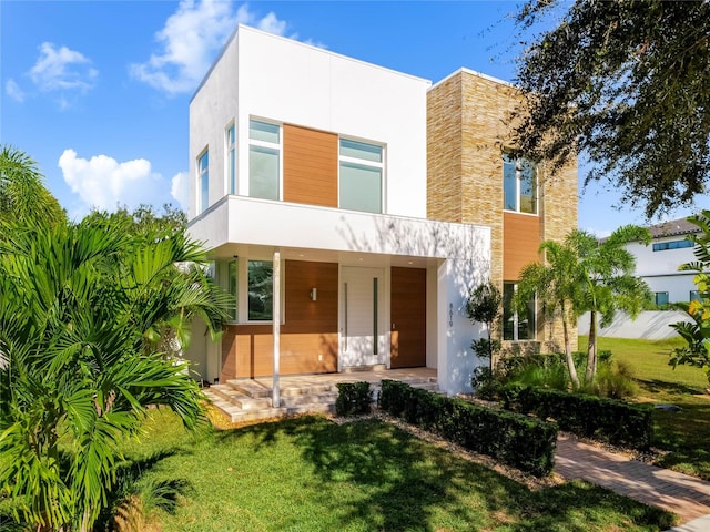 contemporary home featuring a front lawn