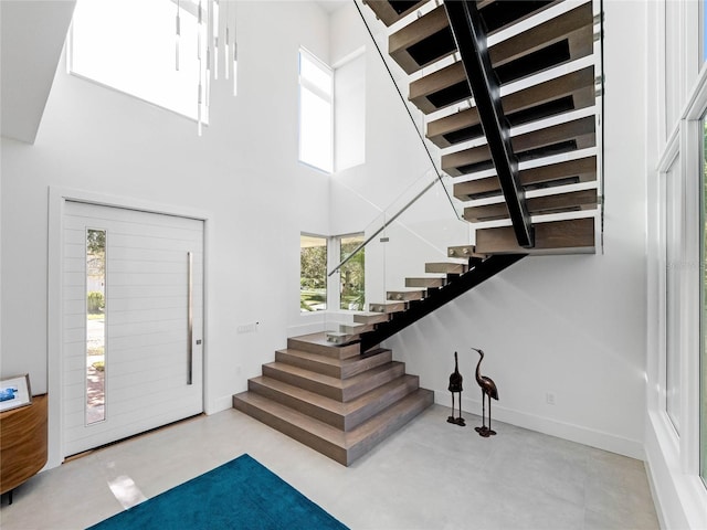 entrance foyer featuring a towering ceiling