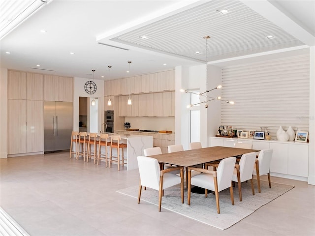 dining space with a towering ceiling and a notable chandelier