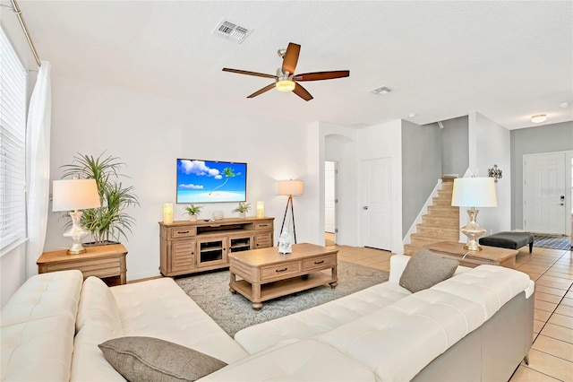 tiled living room with ceiling fan