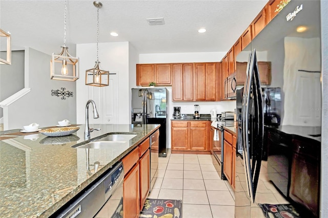 kitchen featuring stone counters, sink, stainless steel appliances, pendant lighting, and light tile patterned floors