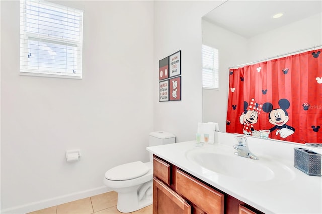 bathroom featuring tile patterned flooring, vanity, toilet, and curtained shower