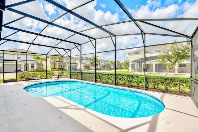 view of swimming pool with a lanai and a patio