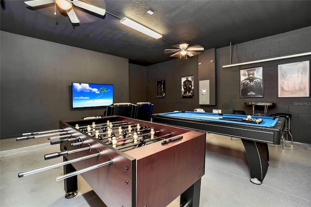 game room with ceiling fan, a textured ceiling, and billiards