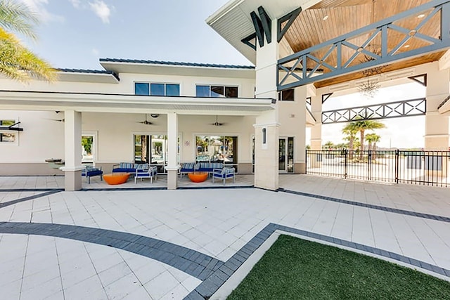 back of house featuring a patio and an outdoor hangout area