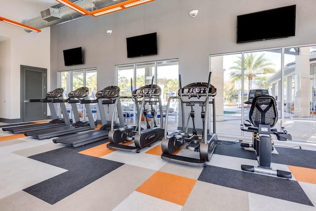 gym with a towering ceiling