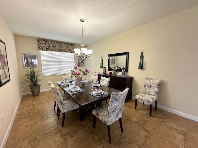 dining area featuring a textured ceiling and an inviting chandelier