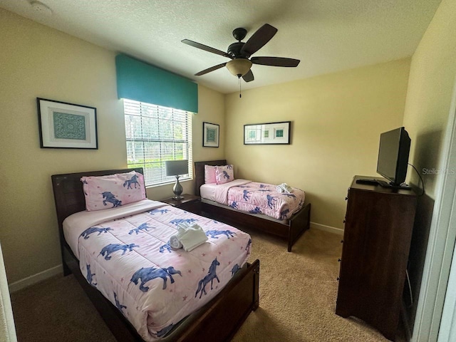 bedroom with carpet flooring, ceiling fan, and a textured ceiling