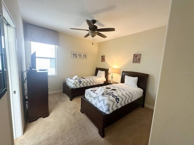 bedroom featuring light carpet and ceiling fan