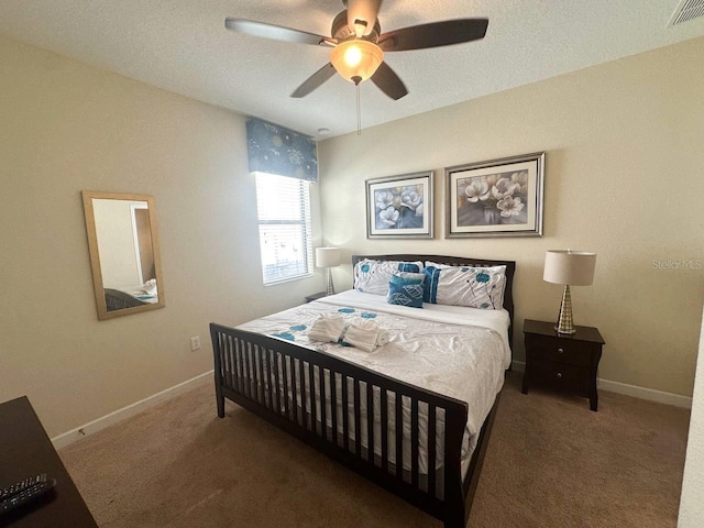 carpeted bedroom with ceiling fan and a textured ceiling