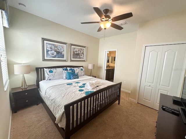 bedroom featuring connected bathroom, carpet floors, a closet, and ceiling fan