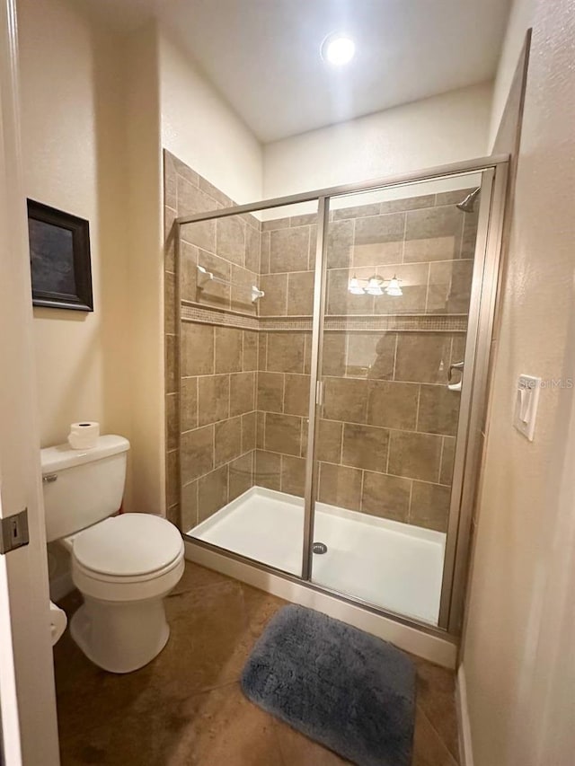 bathroom featuring toilet, tile patterned floors, and walk in shower