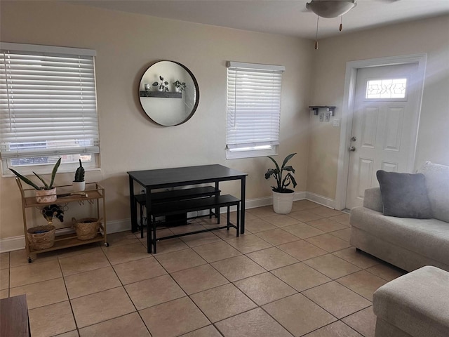 tiled living room featuring ceiling fan