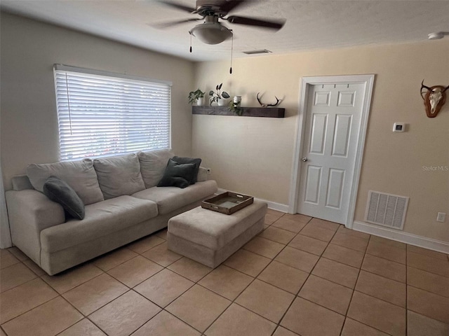 living room featuring ceiling fan and light tile patterned floors