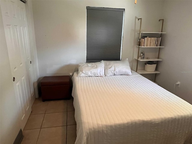 tiled bedroom featuring a closet