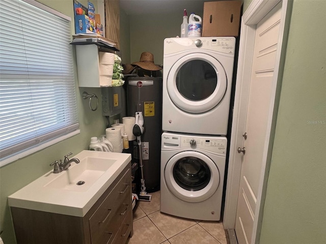 laundry room featuring cabinets, sink, light tile patterned floors, stacked washer / dryer, and water heater