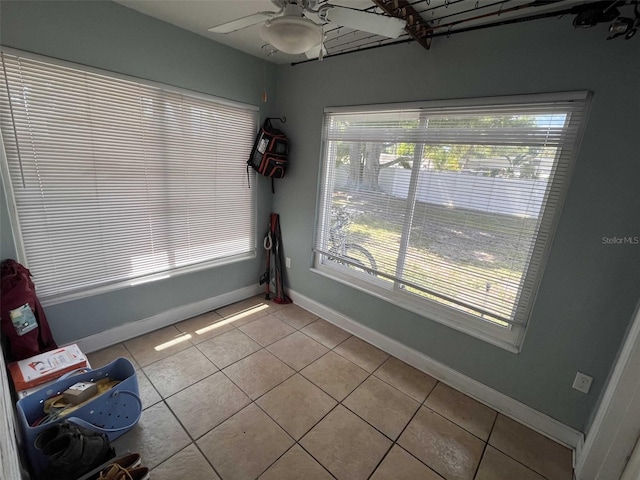 unfurnished dining area with plenty of natural light, light tile patterned floors, and ceiling fan