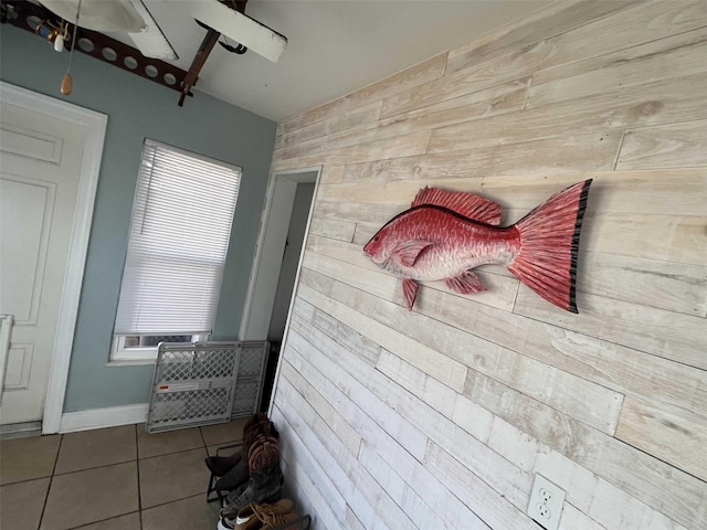 interior space with wooden walls and tile patterned flooring