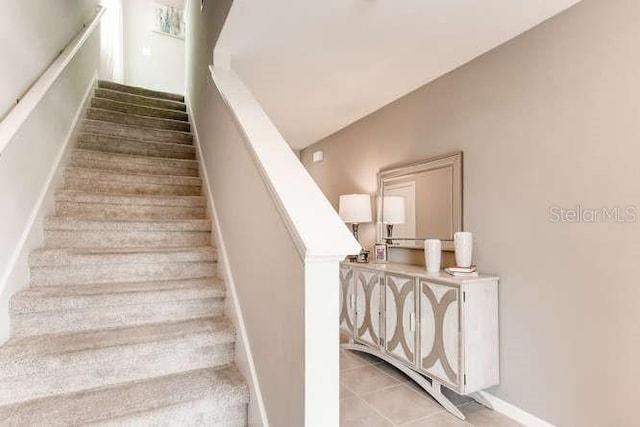 stairs featuring baseboards and tile patterned floors