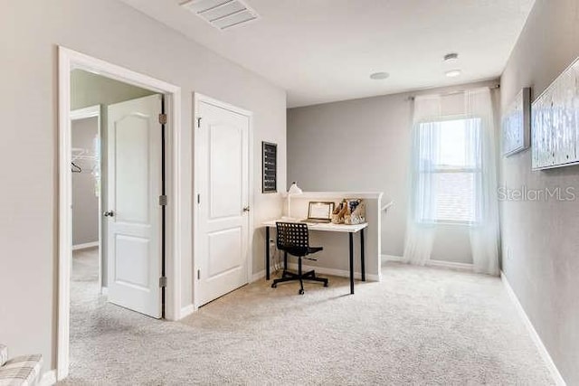 office with light carpet, visible vents, and baseboards