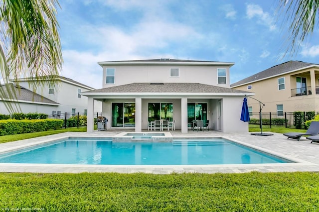 rear view of property featuring a fenced in pool, a patio, and a yard