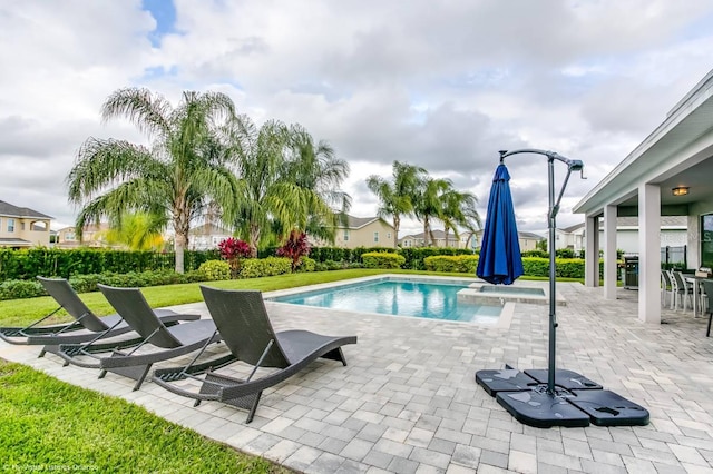 view of pool featuring a patio and a yard