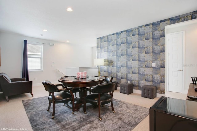 carpeted dining room featuring tile walls