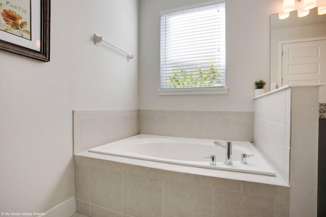 bathroom featuring tiled tub