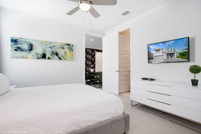 bedroom featuring light colored carpet and ceiling fan