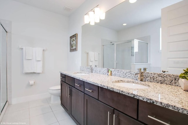 bathroom featuring tile patterned flooring, vanity, toilet, and a shower with shower door