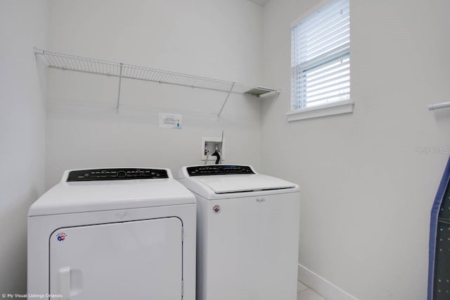 clothes washing area with washing machine and clothes dryer