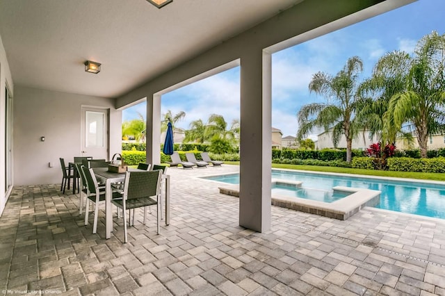 view of pool featuring an in ground hot tub and a patio area