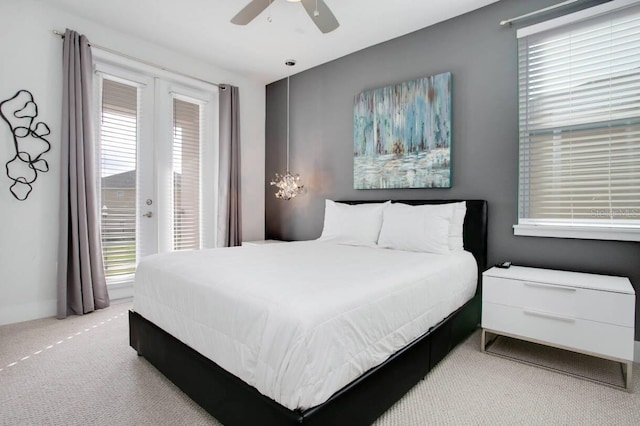 carpeted bedroom featuring multiple windows and ceiling fan