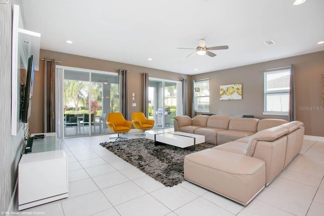 living room with ceiling fan, a healthy amount of sunlight, and light tile patterned floors