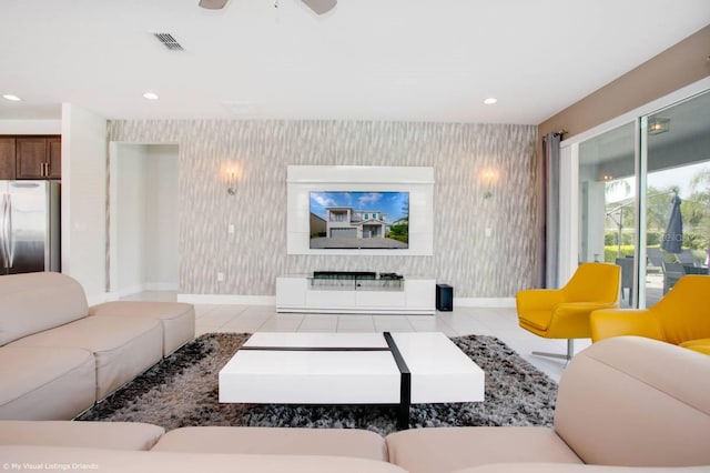 living room featuring ceiling fan and light tile patterned flooring