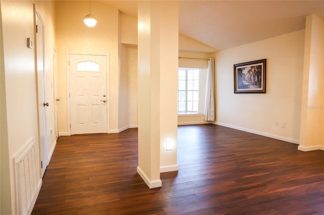 entrance foyer featuring lofted ceiling and dark wood-type flooring