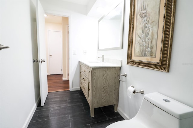 bathroom with vanity, hardwood / wood-style flooring, and toilet