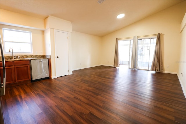 unfurnished living room with dark hardwood / wood-style floors, vaulted ceiling, and sink