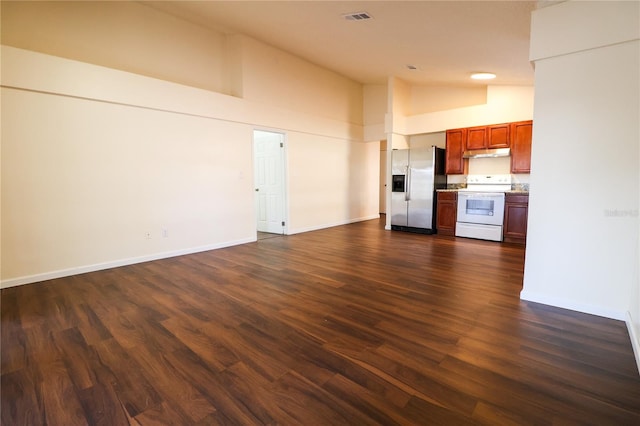 unfurnished living room featuring high vaulted ceiling and dark hardwood / wood-style floors