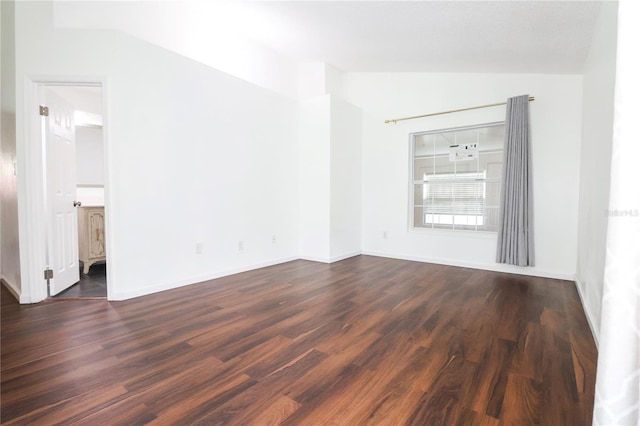 empty room featuring dark hardwood / wood-style flooring and lofted ceiling