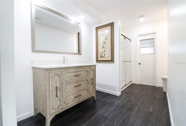 bathroom featuring vanity and a shower with shower door