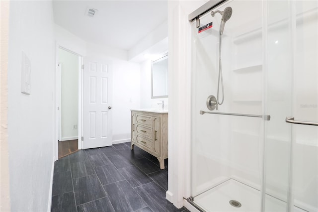 bathroom featuring hardwood / wood-style floors, vanity, and walk in shower