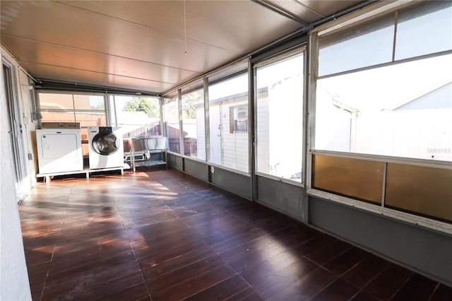 unfurnished sunroom featuring separate washer and dryer